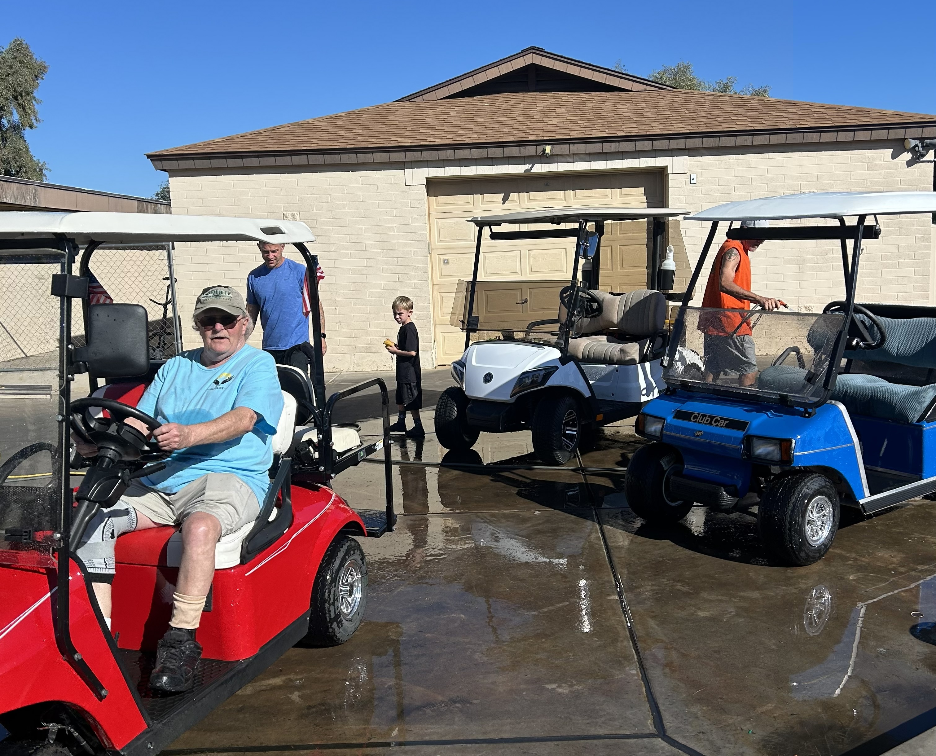 One golf cart washed and two being worked on.