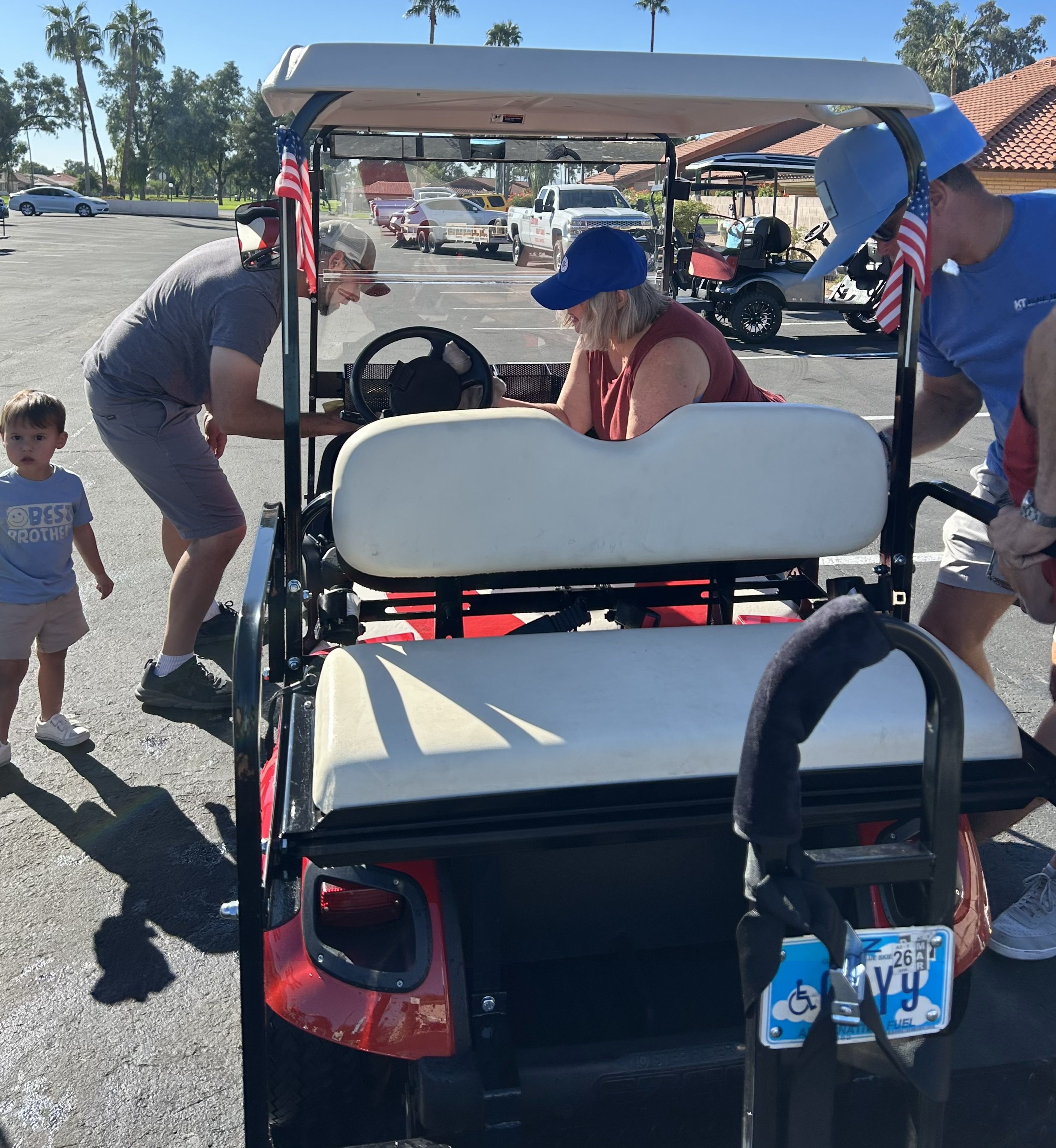 One golf cart washed and two being worked on.